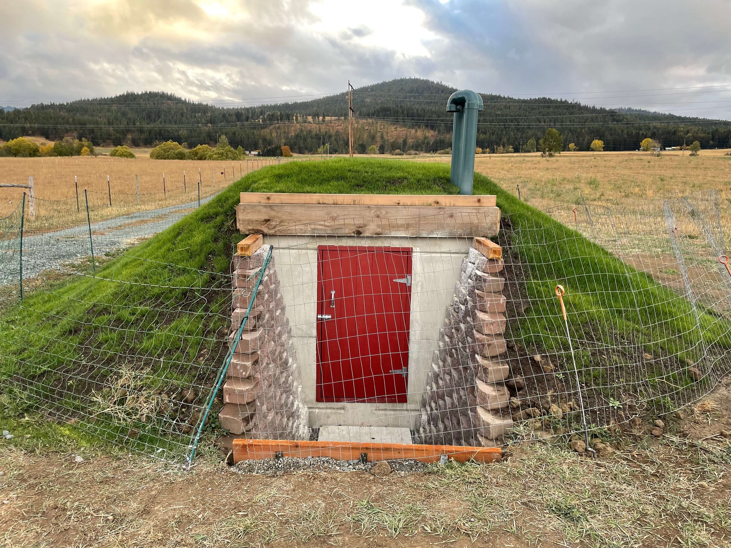 Cheese cave with Concrete water tank half in ground and covered
